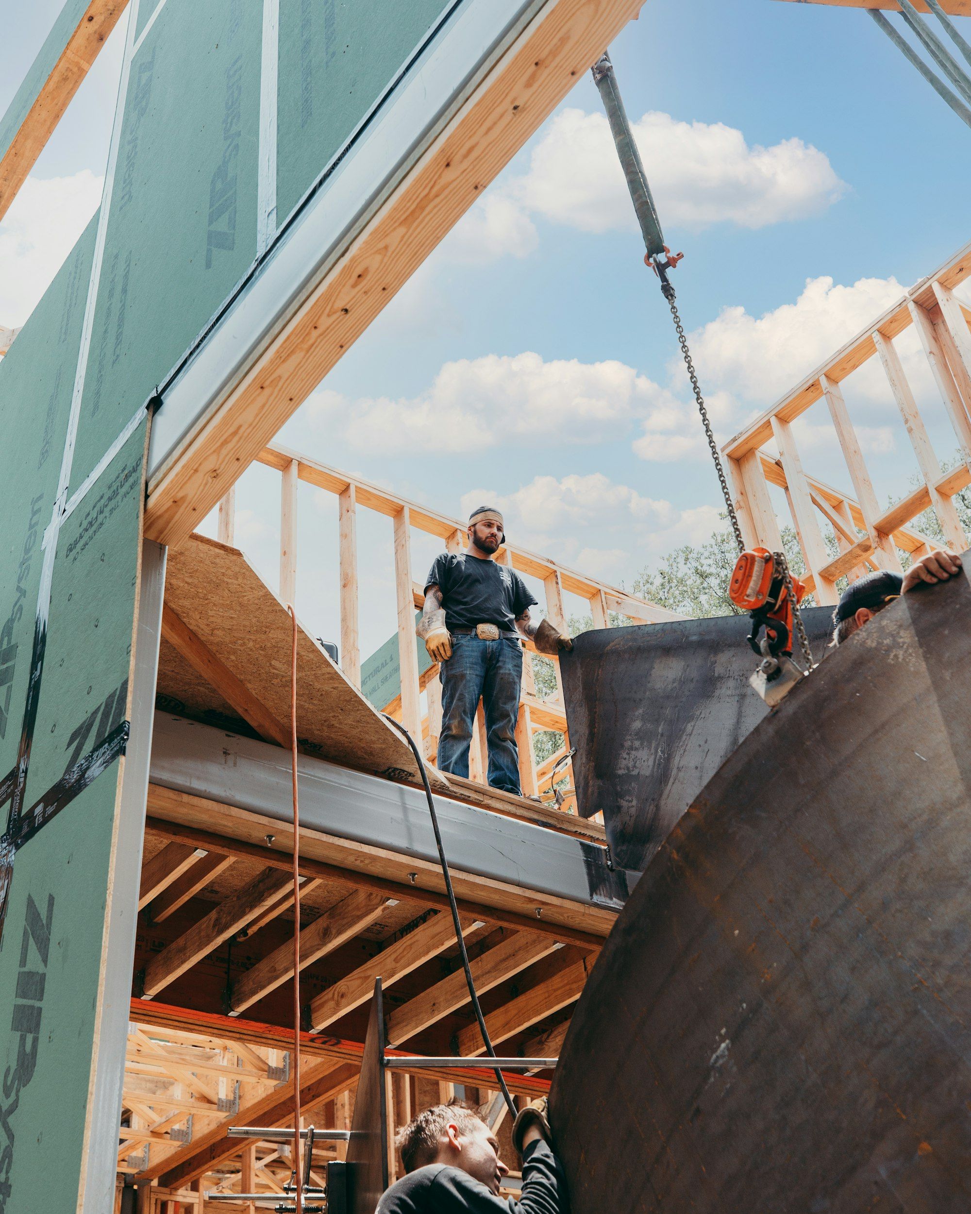 A construction worker standing on timber framing on a building site